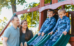 mom and dad watching kids on slide